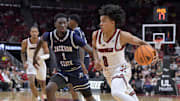 Nov 6, 2025; Louisville, Kentucky, USA;  Louisville Cardinals guard Mikel Brown Jr. (0) drives to the basket against Jackson State Tigers guard Dorian McMillian (1) during the second half at KFC Yum! Center. Louisville defeated Jackson State 106-70. Mandatory Credit: Jamie Rhodes-Imagn Images