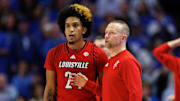 Dec 14, 2024; Lexington, Kentucky, USA; Louisville Cardinals head coach Pat Kelsey talks to guard Chucky Hepburn (24) during the second half against the Kentucky Wildcats at Rupp Arena at Central Bank Center.