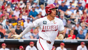 Jun 14, 2025; Omaha, Neb, USA; Arkansas Razorbacks shortstop Wehiwa Aloy (9) runs after hitting a single against the LSU Tigers during the fourth inning at Charles Schwab Field. Mandatory Credit: Dylan Widger-Imagn Images