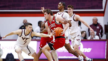 Jan 15, 2025; Blacksburg, Virginia, USA; North Carolina State Wolfpack forward Ben Middlebrooks (34) handles the ball against Virginia Tech Hokies forward Tobi Lawal (1) and guard Brandon Rechsteiner (7) during the first half at Cassell Coliseum. Mandatory Credit: Peter Casey-Imagn Images