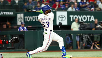 Aug 26, 2025; Arlington, Texas, USA; Texas Rangers right fielder Adolis Garcia (53) hits an rbi double during the first inning against the Los Angeles Angels at Globe Life Field. 