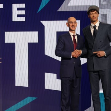 Jun 26, 2024; Brooklyn, NY, USA; Tidjane Salaun poses for photos with NBA commissioner Adam Silver after being selected in the first round by the Charlotte Hornets in the 2024 NBA Draft at Barclays Center. Mandatory Credit: Brad Penner-USA TODAY Sports