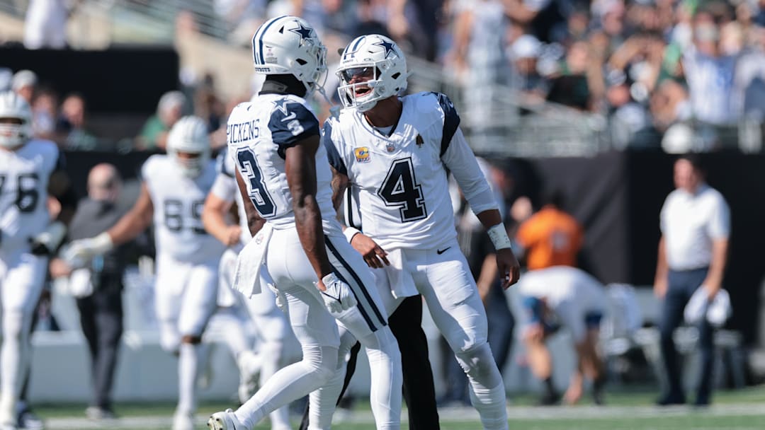 Oct 5, 2025; East Rutherford, New Jersey, USA; Dallas Cowboys quarterback Dak Prescott (4) reacts with wide receiver George Pickens (3) after throwing a touchdown pass against the New York Jets during the first half at MetLife Stadium. Mandatory Credit: Vincent Carchietta-Imagn Images