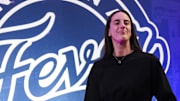 Indiana Fever guard Caitlin Clark (22) walks past the photo backdrop before a game between the Indiana Fever and the Connecticut Sun at Gainbridge Fieldhouse.