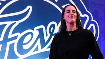 Indiana Fever guard Caitlin Clark (22) walks past the photo backdrop Wednesday, Aug. 28, 2024, during a game between the Indiana Fever and the Connecticut Sun at Gainbridge Fieldhouse in Indianapolis.