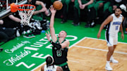 Apr 29, 2025; Boston, Massachusetts, USA; Boston Celtics center Kristaps Porzingis (8) makes the basket against Orlando Magic forward Paolo Banchero (5) in the first quarter during game five of first round for the 2025 NBA Playoffs at TD Garden. Mandatory Credit: David Butler II-Imagn Images
