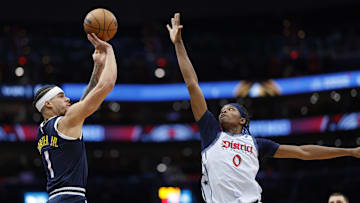 Dec 7, 2024; Washington, District of Columbia, USA; Denver Nuggets forward Michael Porter Jr. (1) shoots the ball over Washington Wizards guard Bilal Coulibaly (0) in the first quarter at Capital One Arena. Mandatory Credit: Geoff Burke-Imagn Images