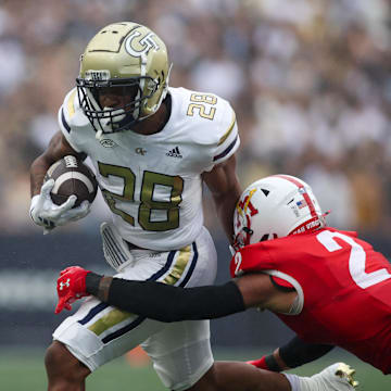 Sep 14, 2024; Atlanta, Georgia, USA; Georgia Tech Yellow Jackets running back Trelain Maddox (28) is tackled by Virginia Military Institute Keydets defensive back Shamus Jones (2) in the second quarter at Bobby Dodd Stadium at Hyundai Field. Mandatory Credit: Brett Davis-Imagn Images