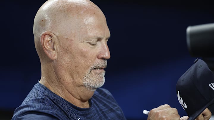 Jun 21, 2025; Miami, Florida, USA;  Atlanta Braves manager Brian Snitker (43) signs autographs against the Miami Marlins before the game at loanDepot Park. Mandatory Credit: Rhona Wise-Imagn Images