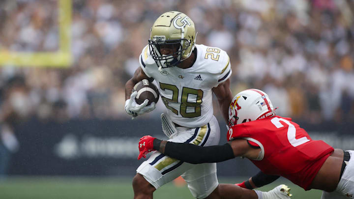 Sep 14, 2024; Atlanta, Georgia, USA; Georgia Tech Yellow Jackets running back Trelain Maddox (28) is tackled by Virginia Military Institute Keydets defensive back Shamus Jones (2) in the second quarter at Bobby Dodd Stadium at Hyundai Field. Mandatory Credit: Brett Davis-Imagn Images