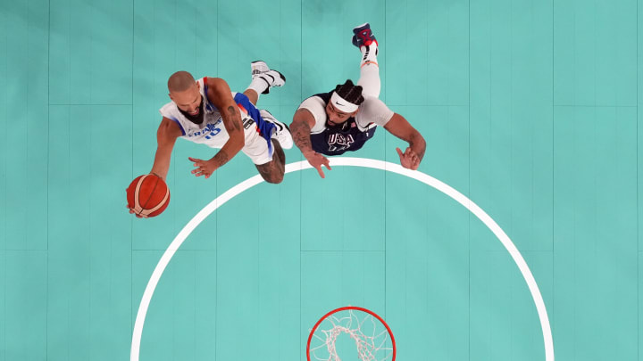 France shooting guard Evan Fournier (10) shoots against United States centre Anthony Davis (14) in men's basketball gold medal at the Paris 2024 Olympic Summer Games at Accor Arena. 