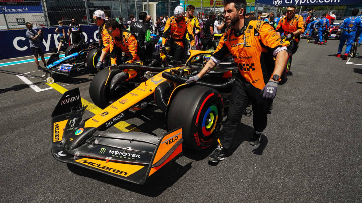 May 4, 2024; Miami Gardens, Florida, USA; Crewmembers push the car of McLaren driver Lando Norris (4) on the grid before the F1 Sprint Race at Miami International Autodrome. Mandatory Credit: John David Mercer-USA TODAY Sports