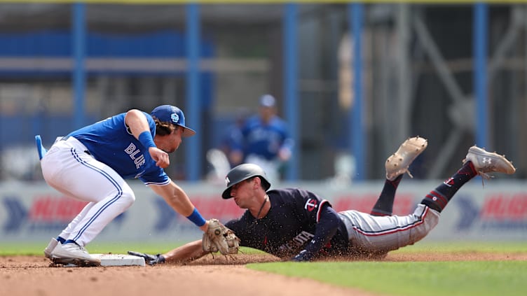 Mar 8, 2023; Dunedin, Florida, USA;  Minnesota Twins shortstop Brooks Lee (72) steals second base from Toronto Blue Jays shortstop Addison Barger (44) in the fifth inning during spring training at TD Ballpark. Mandatory Credit: Nathan Ray Seebeck-USA TODAY Sports