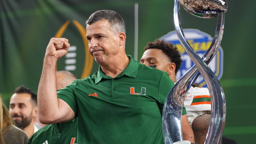 Dec 31, 2025; Arlington, TX, USA; Miami Hurricanes head coach Mario Cristobal with the champions trophy following the 2025 Cotton Bowl and quarterfinal game of the College Football Playoff against the Ohio State Buckeyes at AT&T Stadium. Mandatory Credit: Raymond Carlin III-Imagn Images Dec 31, 2025; Arlington, TX, USA; Miami Hurricanes head coach Mario Cristobal with the champions trophy following the 2025 Cotton Bowl and quarterfinal game of the College Football Playoff against the Ohio State Buckeyes at AT&T Stadium. Mandatory Credit: Raymond Carlin III-Imagn Images