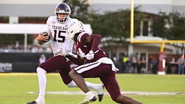 Oct 19, 2024; Starkville, Mississippi, USA;  Texas A&M Aggies quarterback Conner Weigman (15) runs the ball against Mississippi State Bulldogs cornerback Brice Pollock (14) during the third quarter at Davis Wade Stadium at Scott Field. Mandatory Credit: Matt Bush-Imagn Images