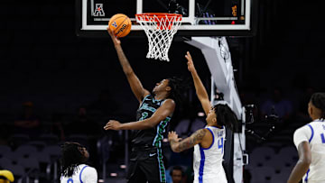 Mar 15, 2025; Fort Worth, TX, USA;  Tulane Green Wave guard Kam Williams (3) scores a layup against Memphis Tigers guard PJ Haggerty (4) during the second half at Dickies Arena. Mandatory Credit: Chris Jones-Imagn Images