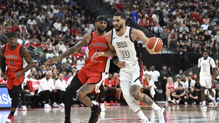 Jul 10, 2024; Las Vegas, Nevada, USA; USA forward Jayson Tatum (10) dribbles past Canada guard Nickeil Alexander-Walker (1) in the first quarter in the USA Basketball Showcase at T-Mobile Arena. Mandatory Credit: Candice Ward-USA TODAY Sports