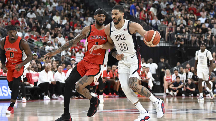 Jul 10, 2024; Las Vegas, Nevada, USA; USA forward Jayson Tatum (10) dribbles past Canada guard Nickeil Alexander-Walker (1) in the first quarter in the USA Basketball Showcase at T-Mobile Arena. Mandatory Credit: Candice Ward-USA TODAY Sports