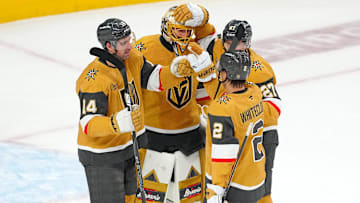 Apr 20, 2025; Las Vegas, Nevada, USA; Vegas Golden Knights goaltender Adin Hill (33) celebrates with defenseman Nicolas Hague (14), defenseman Shea Theodore (27), and defenseman Zach Whitecloud (2) after they defeated the Minnesota Wild 4-2 in game one of the first round of the 2025 Stanley Cup Playoffs at T-Mobile Arena. Mandatory Credit: Stephen R. Sylvanie-Imagn Images