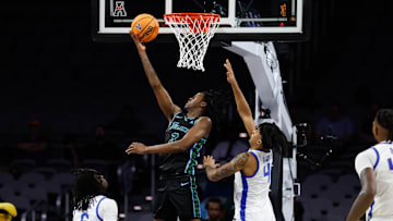 Mar 15, 2025; Fort Worth, TX, USA;  Tulane Green Wave guard Kam Williams (3) scores a layup against Memphis Tigers guard PJ Haggerty (4) during the second half at Dickies Arena.