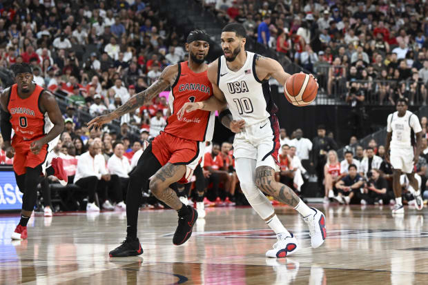 USA forward Jayson Tatum dribbles down the court.