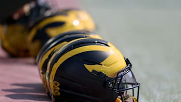 Sep 6, 2025; Norman, Oklahoma, USA; Michigan Wolverine helmets sit on the field near the sideline prior to a game against the Oklahoma Sooners at Gaylord Family-Oklahoma Memorial Stadium. Mandatory Credit: Kevin Jairaj-Imagn Images