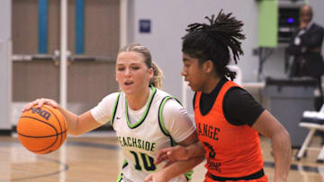 Beachside guard Morgan Cremen (10) dribbles into the lane as Orange Park guard Mariah Young (3) defends during an FHSAA Region 1-5A high school girls basketball playoff on Feb. 13, 2025. [Clayton Freeman/Florida Times-Union]