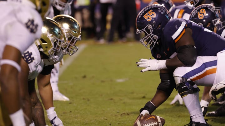 Nov 13, 2021; Charlottesville, Virginia, USA; Virginia Cavaliers center Olusegun Oluwatimi (55) snaps the ball against the Notre Dame Fighting Irish at Scott Stadium. The Cavaliers will face the Fighting Irish on November 16th. Mandatory Credit: Geoff Burke-USA TODAY Sports