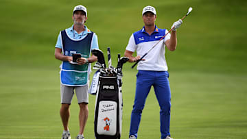 Aug 22, 2024; Castle Rock, Colorado, USA; Viktor Hovland and his caddie prepare for the second shot on the first hole during the first round of the BMW Championship golf tournament at Castle Pines Golf Club. Mandatory Credit: Christopher Hanewinckel-Imagn Images