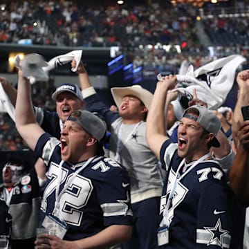 Dallas Cowboys fans cheer on their team from the floor of AT&T Stadium 