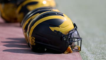 Sep 6, 2025; Norman, Oklahoma, USA; Michigan Wolverine helmets sit on the field near the sideline prior to a game against the Oklahoma Sooners at Gaylord Family-Oklahoma Memorial Stadium. Mandatory Credit: Kevin Jairaj-Imagn Images