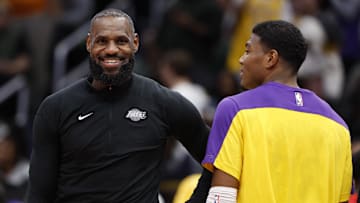 Jan 30, 2025; Washington, District of Columbia, USA; Jan 29, 2025; Washington, District of Columbia, USA; Los Angeles Lakers forward LeBron James (L) and Lakers forward Rui Hachimura (R) joke on the bench against the Washington Wizards in the third quarter at Capital One Arena. Mandatory Credit: Geoff Burke-Imagn Images