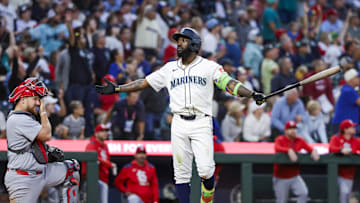 Sep 9, 2025; Seattle, Washington, USA; Seattle Mariners left fielder Randy Arozarena (56) reacts towards the Mariners dugout after hitting a three-run home run against the St. Louis Cardinals during the third inning at T-Mobile Park. St. Louis Cardinals catcher Pedro Pages (43) kneels at left. Mandatory Credit: Joe Nicholson-Imagn Images