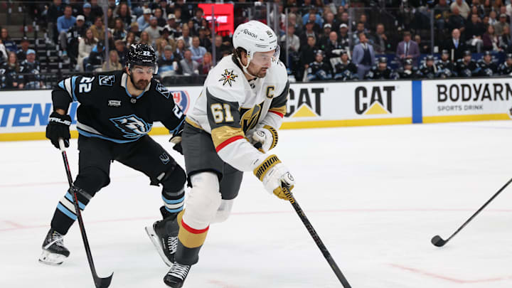 May 1, 2026; Salt Lake City, Utah, USA; Vegas Golden Knights right wing Mark Stone (61) plays the puck against Utah Mammoth center Jack McBain (22) during the first period in game six of the first round of the 2026 Stanley Cup Playoffs at Delta Center. Mandatory Credit: Rob Gray-Imagn Images