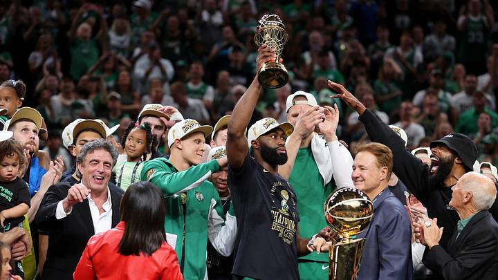 Jun 17, 2024; Boston, Massachusetts, USA; Boston Celtics guard Jaylen Brown (7) holds the MVP trophy after winning the 2024 NBA Finals against the Dallas Mavericks at TD Garden. Mandatory Credit: Peter Casey-Imagn Images