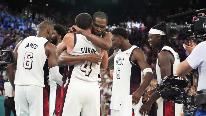 Aug 8, 2024; Paris, France; United States shooting guard Stephen Curry (4) and guard Kevin Durant (7) embrace after the game against Serbia in a men's basketball semifinal game during the Paris 2024 Olympic Summer Games at Accor Arena. Mandatory Credit: Rob Schumacher-USA TODAY Sports