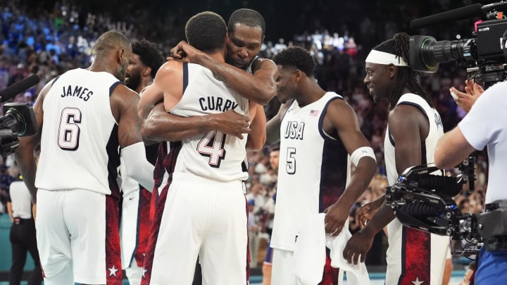 Aug 8, 2024; Paris, France; United States shooting guard Stephen Curry (4) and guard Kevin Durant (7) embrace after the game against Serbia in a men's basketball semifinal game during the Paris 2024 Olympic Summer Games at Accor Arena. Mandatory Credit: Rob Schumacher-USA TODAY Sports