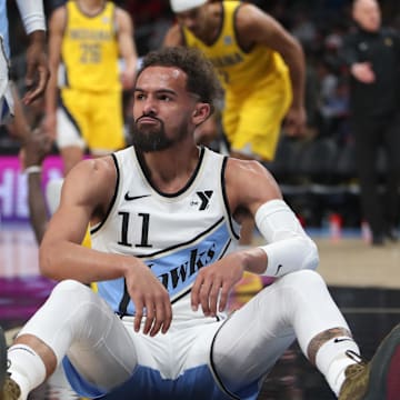 Mar 8, 2025; Atlanta, Georgia, USA; Atlanta Hawks guard Trae Young (11) sits on the court after being fouled by Indiana Pacers forward Pascal Siakam (43) during the first quarter at State Farm Arena. Mandatory Credit: Mady Mertens-Imagn Images
