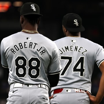 Jul 25, 2024; Arlington, Texas, USA; Chicago White Sox center fielder Luis Robert Jr. (88) and designated hitter Eloy Jimenez (74) warm up before a game against the Texas Rangers at Globe Life Field.