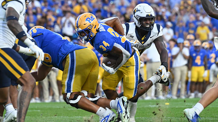 Sep 14, 2024; Pittsburgh, Pennsylvania, USA; Pittsburgh Panthers running back Derrick Davis Jr. (34) scores a touchdown against the West Virginia Mountaineers during the fourth quarter at Acrisure Stadium. Mandatory Credit: Barry Reeger-Image Images