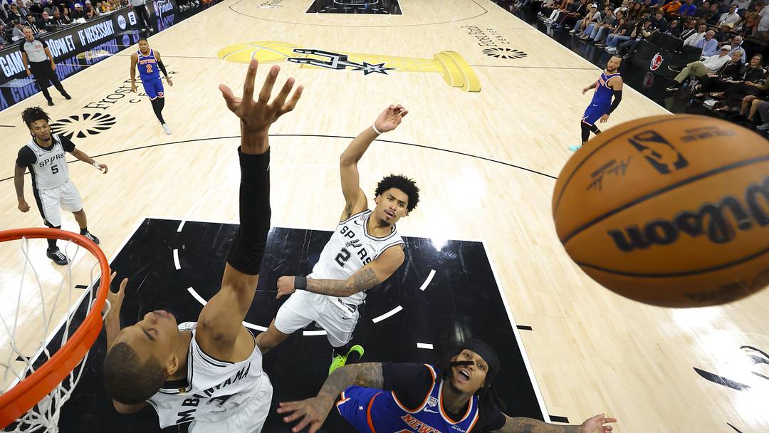 Jun 13, 2026; San Antonio, Texas, USA; San Antonio Spurs forward Victor Wembanyama (1) and guard Dylan Harper (2) and New York Knicks guard Jordan Clarkson (00) battle for the rebound during game five of the 2026 NBA Finals at Frost Bank Center. Mandatory Credit: Geoff Burke-Pool Photo via Imagn Images