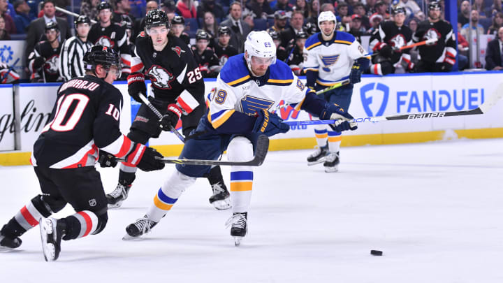 Nov 23, 2022; Buffalo, New York, USA; St. Louis Blues left wing Pavel Buchnevich (89) and Buffalo Sabres defenseman Henri Jokiharju (10) go after the puck in the first period against the Buffalo Sabres at KeyBank Center. Mandatory Credit: Mark Konezny-USA TODAY Sports