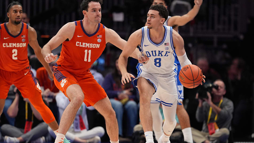 Mar 13, 2026; Charlotte, NC, USA; Duke Blue Devils guard Darren Harris (8) handles the ball guarded by Clemson Tigers forward Nick Davidson (11) during the second half at Spectrum Center. Mandatory Credit: Jim Dedmon-Imagn Images