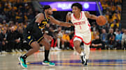 May 2, 2025; San Francisco, California, USA; Houston Rockets forward Amen Thompson (1) dribbles past Golden State Warriors guard Buddy Hield (7) in the second quarter of game six of the first round for the 2025 NBA Playoffs at Chase Center. Mandatory Credit: Cary Edmondson-Imagn Images