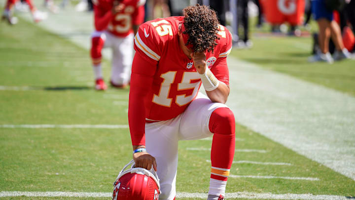 Aug 17, 2024; Kansas City, Missouri, USA; Kansas City Chiefs quarterback Patrick Mahomes (15) kneels on field against the Detroit Lions prior to the game at GEHA Field at Arrowhead Stadium. Mandatory Credit: Denny Medley-Imagn Images