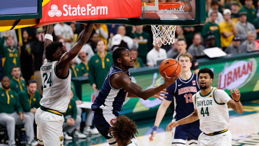 Feb 24, 2026; Waco, Texas, USA;  Arizona Wildcats guard Jaden Bradley (0) scores a reverse layup ahead of Baylor Bears guard Tounde Yessoufou (24) during the first half at Paul and Alejandra Foster Pavilion. Mandatory Credit: Chris Jones-Imagn Images