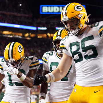 Green Bay Packers wide receiver Dontayvion Wicks (13) and wide receiver Romeo Doubs (87) and tight end Tucker Kraft (85) celebrate after wide receiver Bo Melton (80) scored a touchdown against the San Francisco 49ers.
