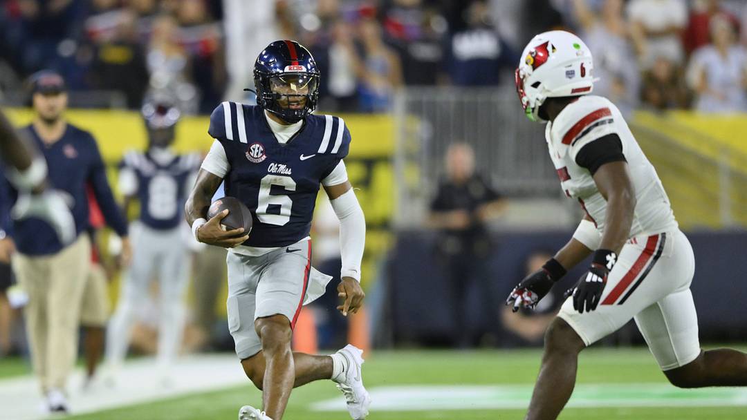 Mississippi Rebels quarterback Trinidad Chambliss (6) carries the ball against the Louisville Cardinals during the fourth quarter at Nissan Stadium.  Mandatory Credit: Steve Roberts-Imagn Images