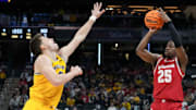 Michigan Wolverines forward Will Tschetter (42) guards Wisconsin Badgers guard John Blackwell (25) as he shoots during the first half of the 2025 TIAA Big Ten Men’s Basketball Tournament final game on Sunday, March 16, 2025, at Gainbridge Fieldhouse in Indianapolis.