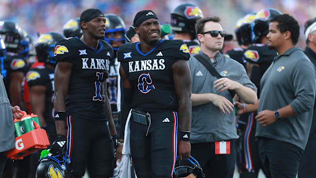 Kansas Jayhawks quarterback Jalon Daniels (6) watches a replay alongside Kansas Jayhawks wide receiver Emmanuel Henderson Jr